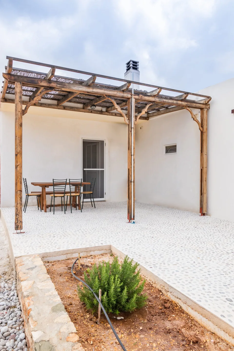 White entrance and pergola at Sea La Vue accommodation in Lefkos Karpathos