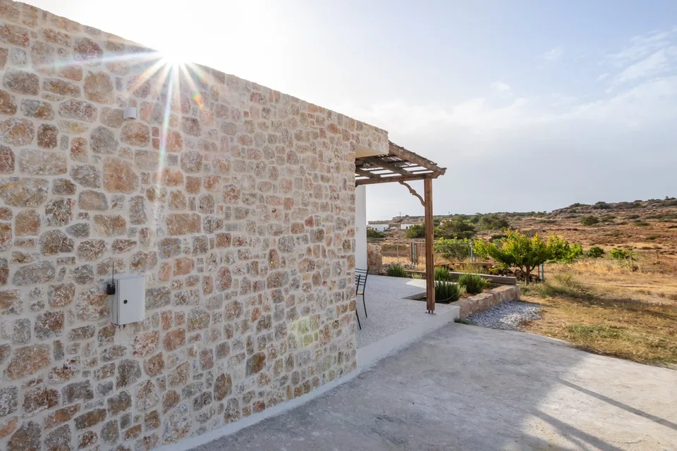 Stone exterior wall of Sea La Vue holiday home in Karpathos