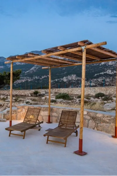 Traditional alona patio with wooden pergola at Sea La Vue in Karpathos